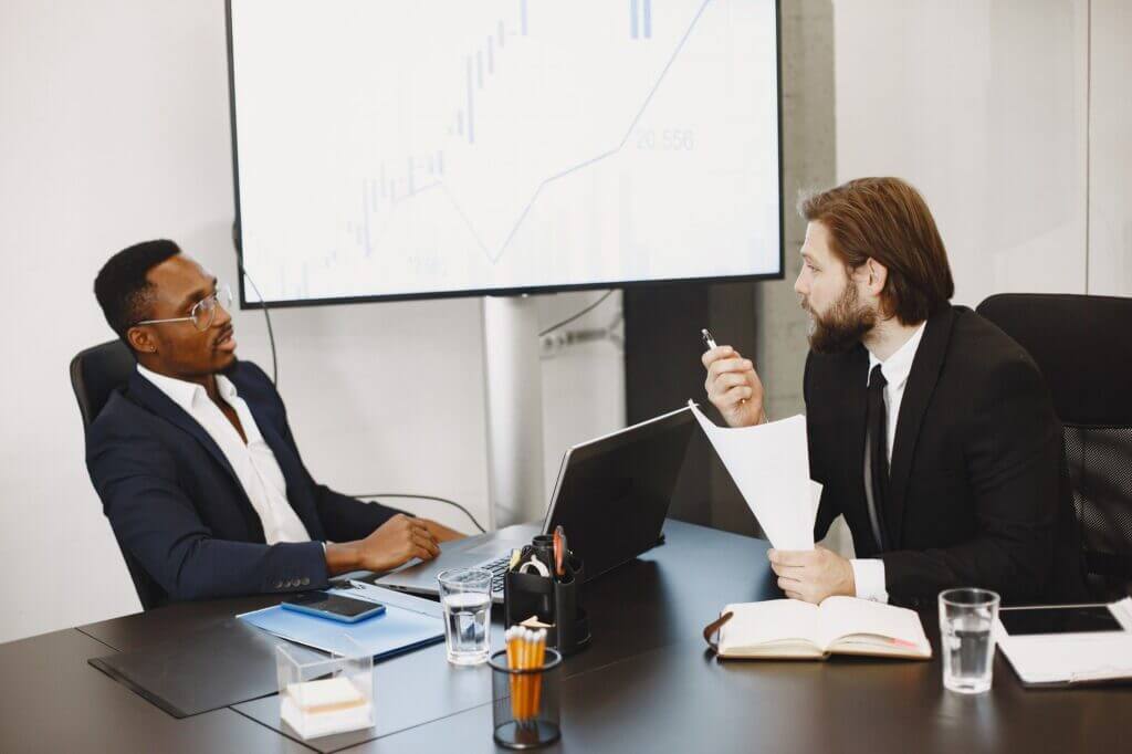 One black and one white man talking about Socio Economic Development