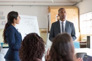 cheerful-young-speakers-standing-near-whiteboard-skills-development-create-infinity-2023